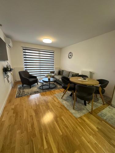 a living room with a couch and a table at ZORA apartmani Sarajevo in Sarajevo