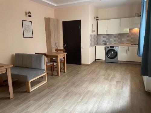 a living room with a table and a kitchen at Гостьовий будинок Arсadia in Odesa