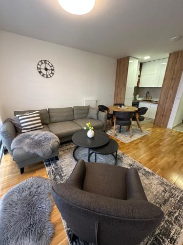 a living room with a couch and chairs and tables at ZORA apartmani Sarajevo in Sarajevo