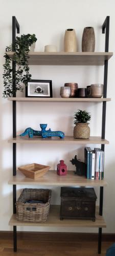 a shelf with books and other items on it at Casa Milla in Tremezzo