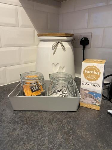 a container of food sitting on a counter next to a box at Triple Deck Cottage - 2mins from Mevagissey Harbour in Mevagissey