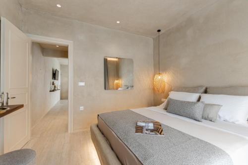 a bedroom with a bed with a tray on it at Villa Adriana Hotel in Agios Prokopios