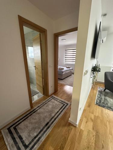 a hallway with a door leading to a living room at ZORA apartmani Sarajevo in Sarajevo