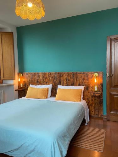 a bedroom with a large bed with a blue wall at Dolce vita Assisi flat two bedrooms two bathrooms in Assisi
