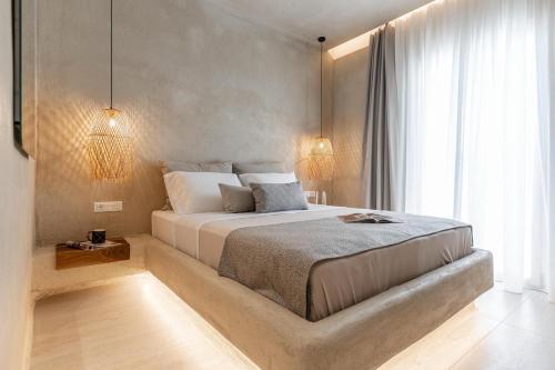 a bedroom with a large bed and a large window at Villa Adriana Hotel in Agios Prokopios