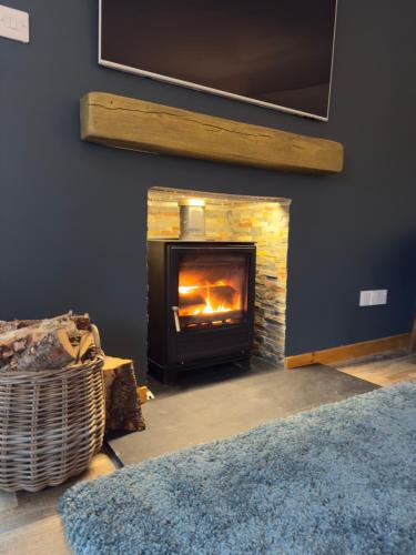 a fireplace in a living room with a fire place at Sea Room, Scalpay in Scalpay