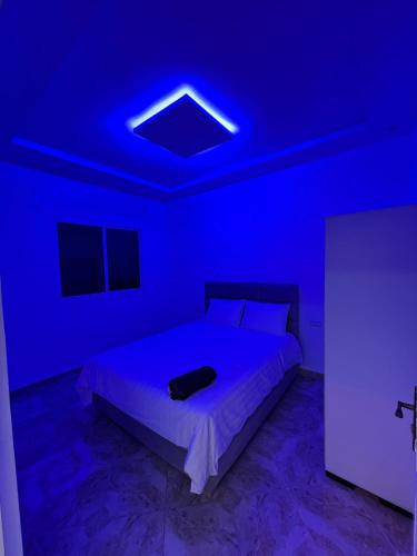 a bedroom with a bed with a blue light at luxe appartement Nour D'asilah 1 WiFi 5G in Asilah