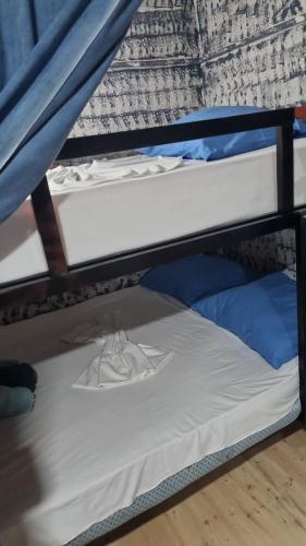 a bunk bed in a room with a mattress at War Bunker Hostel in Sarandë