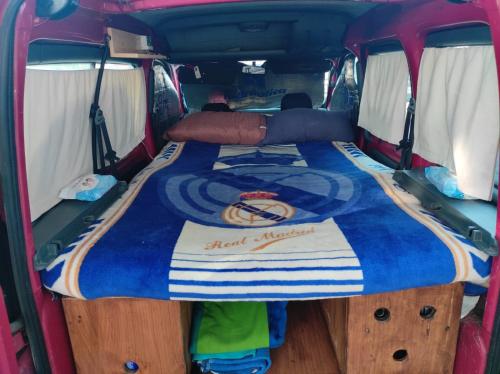 a bed in the back of a van at Camper K Not for driving Playa las Vistas in Adeje
