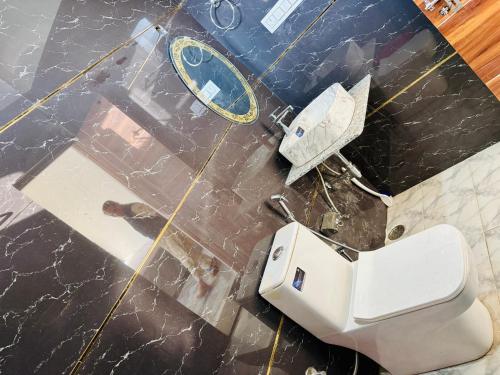 an overhead view of a bathroom with a toilet and a mirror at Juyal palace in Jāmb