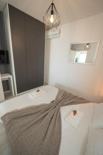 a bedroom with a bed with two flowers on it at Pool and Breakfast Apartments Villa Maro in Novalja