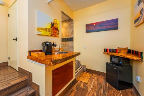 a kitchen with a counter and a sink at Nomads Hotel in San Clemente