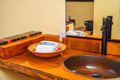 a bathroom counter with a sink and a mirror at Nomads Hotel in San Clemente