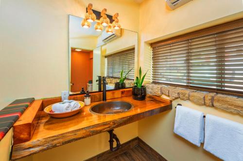 a bathroom with a sink and a mirror at Nomads Hotel in San Clemente