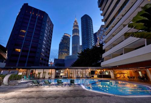 a pool in the middle of a city with tall buildings at Corus Hotel Kuala Lumpur in Kuala Lumpur