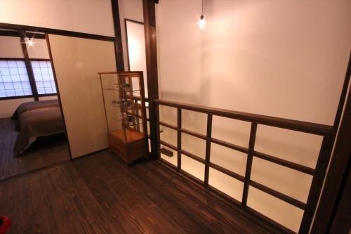a living room with a balcony and a room with a couch at Hashiba-an in Kanazawa