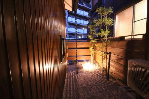 a hallway of a building at night with a plant at Hashiba-an in Kanazawa