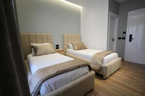 a room with two beds and a couch at Apartments Romario in Sarandë