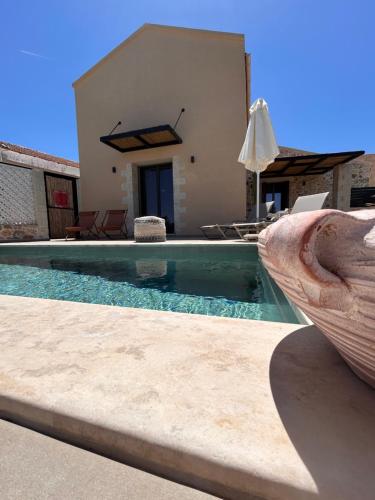 a villa with a swimming pool and a house at Kefalas Luxury Villas Patitiri with Private Pool in Epáno Kefalás