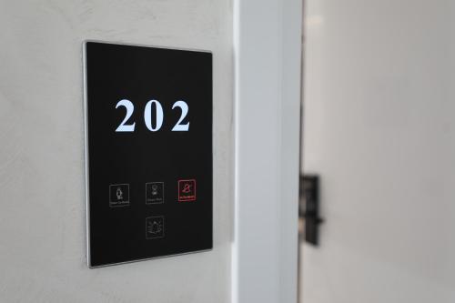 an open door with a clock on the wall at Apartments Romario in Sarandë