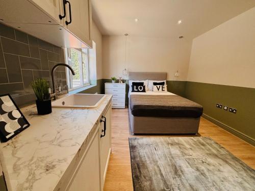 a kitchen with a bed and a sink in a room at Luxury standard flats in Central London, ideal for tourists in Northolt