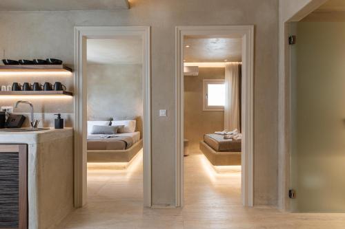 a room with a bed and a kitchen with a mirror at Villa Adriana Hotel in Agios Prokopios