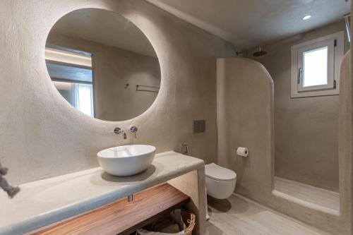 a bathroom with a sink and a mirror at Villa Adriana Hotel in Agios Prokopios