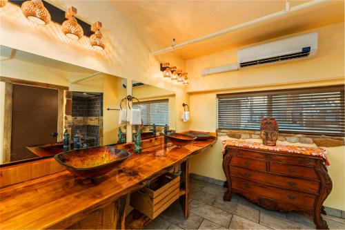 a bathroom with two sinks and a large wooden counter at Nomads Hotel in San Clemente