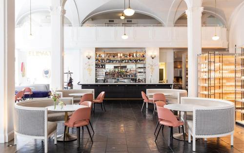 a restaurant with tables and chairs and a bar at Stay, Play and Pass Go at the Monopoly Penthouse! in Richmond