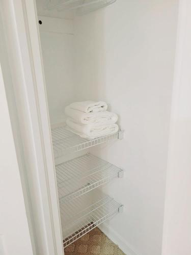 a closet with white towels sitting on shelves at Excellence vacation home in St. John's