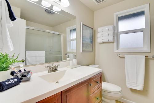 a bathroom with a sink and a toilet and a mirror at Lovely Vancouver Retreat with Home Gym! in Vancouver