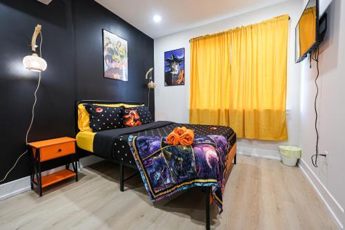 a bedroom with a bed and a yellow curtain at Chill in Style Anime Themed Escape in Philadelphia