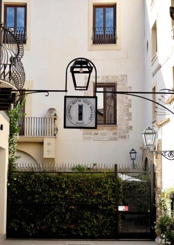 a clock on the side of a building at Sette Fate Suites & Spa in Palermo