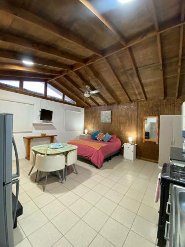 a bedroom with a bed and a table in a room at Loft Tongoy 2 Interior sin vista al mar in Tongoy