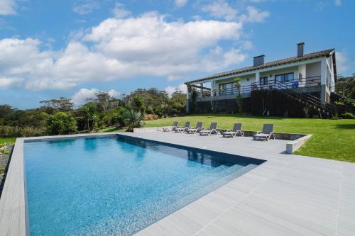a swimming pool in front of a house at Casa das Hortências by Azoresrent in Farroupo