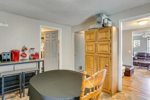 a living room with a table and a kitchen at 3 Mi to Dtwn Fort Wayne Home with Deck and Yard! in Fort Wayne