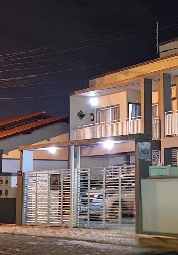 a building with a balcony with a car on it at Apart ZSS in Penha