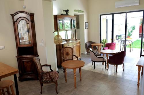 a room with tables and chairs and a room with windows at Sette Fate Suites & Spa in Palermo