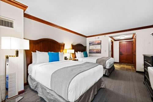a hotel room with two beds and a television at Everline Resort & Spa Palisades- Forest View no resort fee in Olympic Valley
