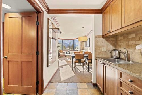 a kitchen with a sink and a dining room at Everline Resort & Spa Palisades-Valley View Suite in Olympic Valley