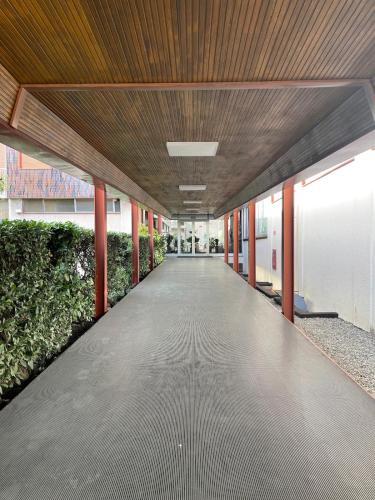 an empty hallway in a building with a wooden ceiling at Pit Stop Apartment 2K23 - MXP - Busto Arsizio in Busto Arsizio