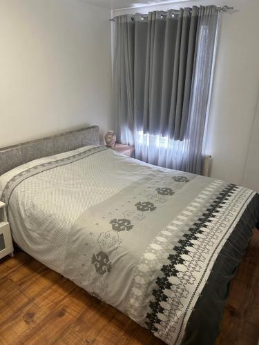 a bedroom with a bed and a window with curtains at Cosy Room in Flat - Central Location in London