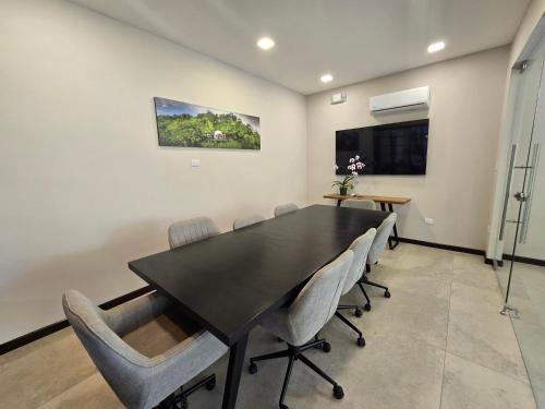 a dining room with a black table and chairs at Chira Glamping Resort Monteverde in Monteverde Costa Rica