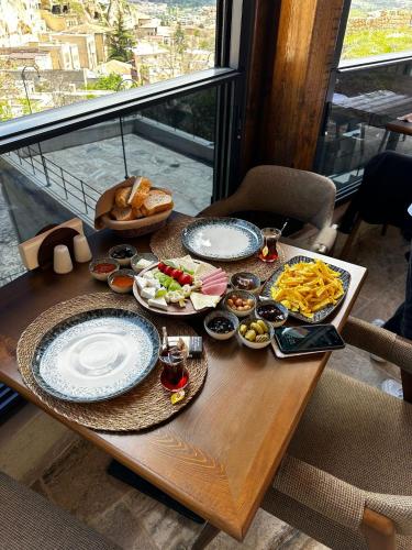 a table with plates of food on top of a window at Lagoon Cave Suites in Urgup