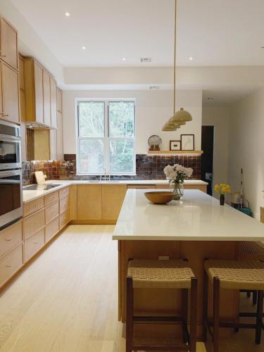a kitchen with a large island in the middle at 3.8 Million Dollar Brownstone Newly Renovated in New York
