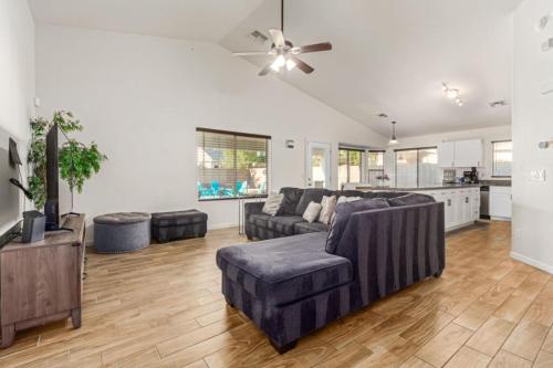 a living room with two couches and a ceiling fan at Beautifully Decorated HomeAvondalePrivatePool in Avondale