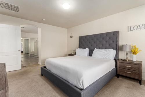 a bedroom with a large bed with a large headboard at Beautifully Decorated HomeAvondalePrivatePool in Avondale