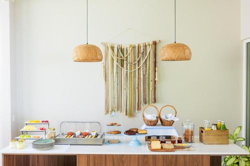 a table with food and baskets and two pendant lights at Chira Glamping Resort Monteverde in Monteverde Costa Rica