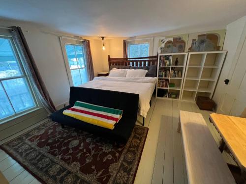 a bedroom with a bed and a chair in it at High Peaks Private Room #4 in a Shared House Homestay in Keene Valley