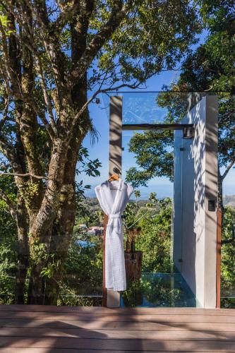 a statue of a woman standing in front of a door at Chira Glamping Resort Monteverde in Monteverde Costa Rica